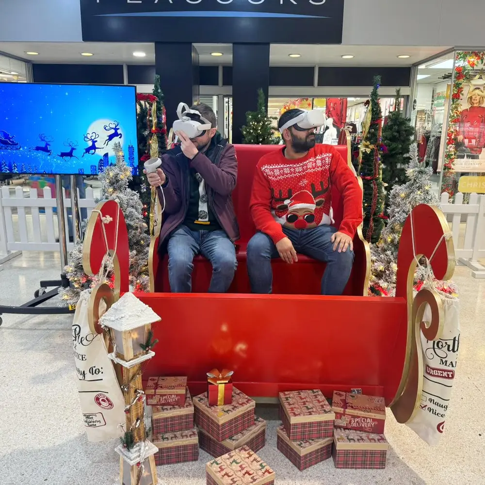 Shoppers wearing VR headsets on a Santa sleigh ride experience in a shopping centre