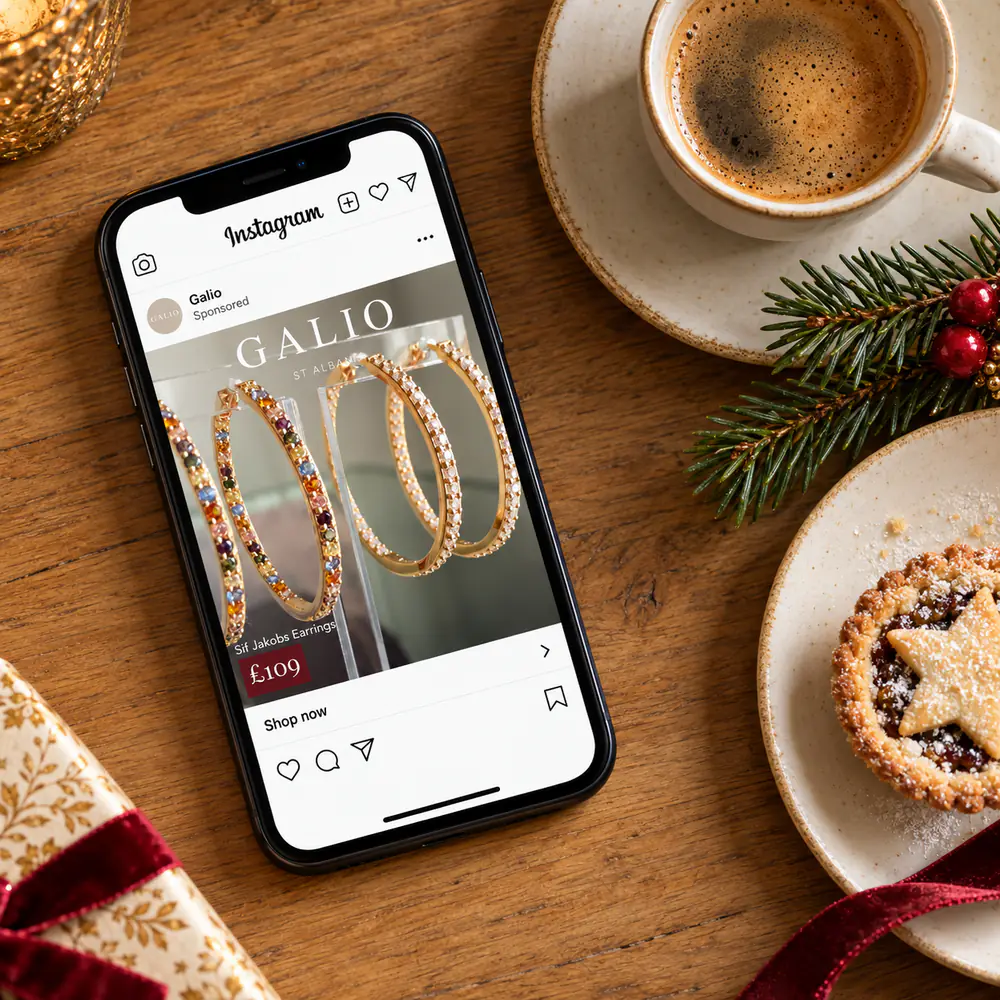 Galio Instagram ad for Sif Jakobs hoop earrings on a phone beside coffee and a mince pie